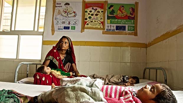 A lady waits for her child to be treated in a hospital.