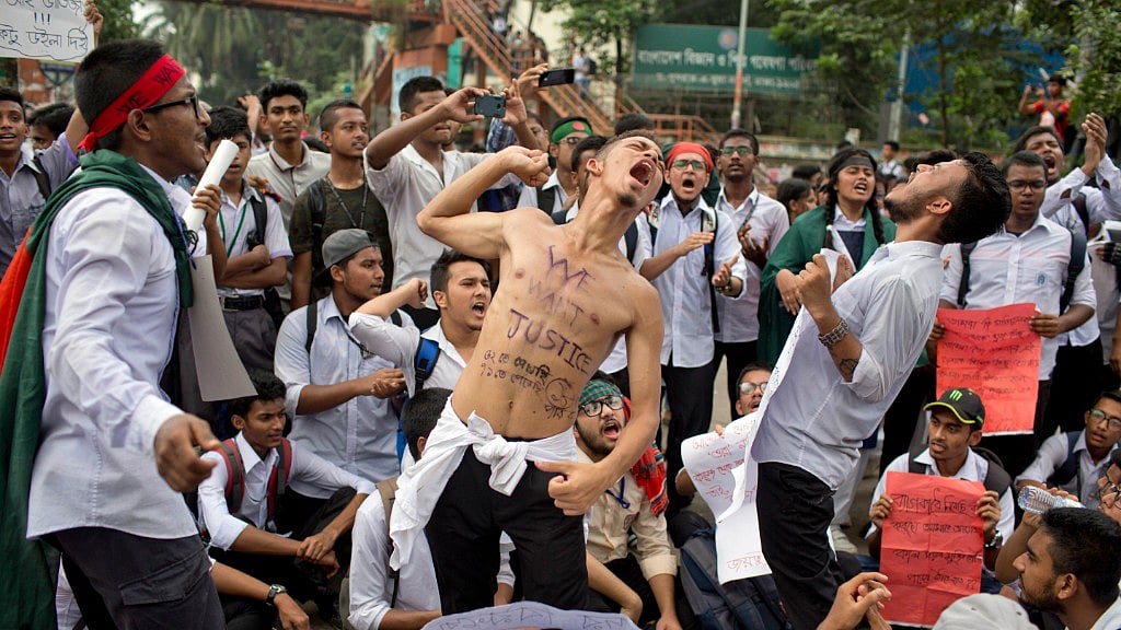 Bangladeshi students shout slogans and block a road during a protest in Dhaka, Bangladesh, Saturday, 4 August 2018.