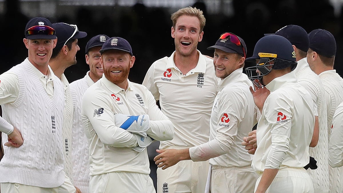 England’s Stuart Broad, centre, stands with his team as India’s Dinesh Karthik leaves the pitch during the fourth day of the second test match between England and India at Lord’s cricket ground in London, Sunday, Aug. 12, 2018.&nbsp;