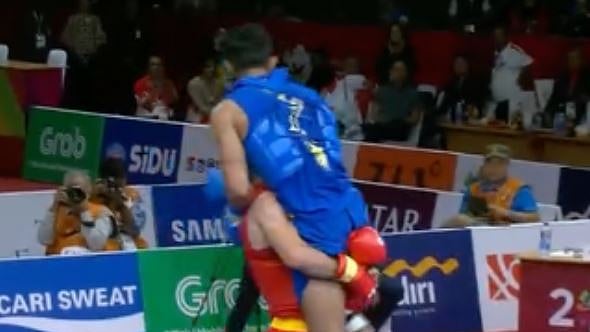 Iran’s Erfan Ahangarian carries India’s injured Surya Bhanu Pratap Singh after their Wushu match at the Asian Games.