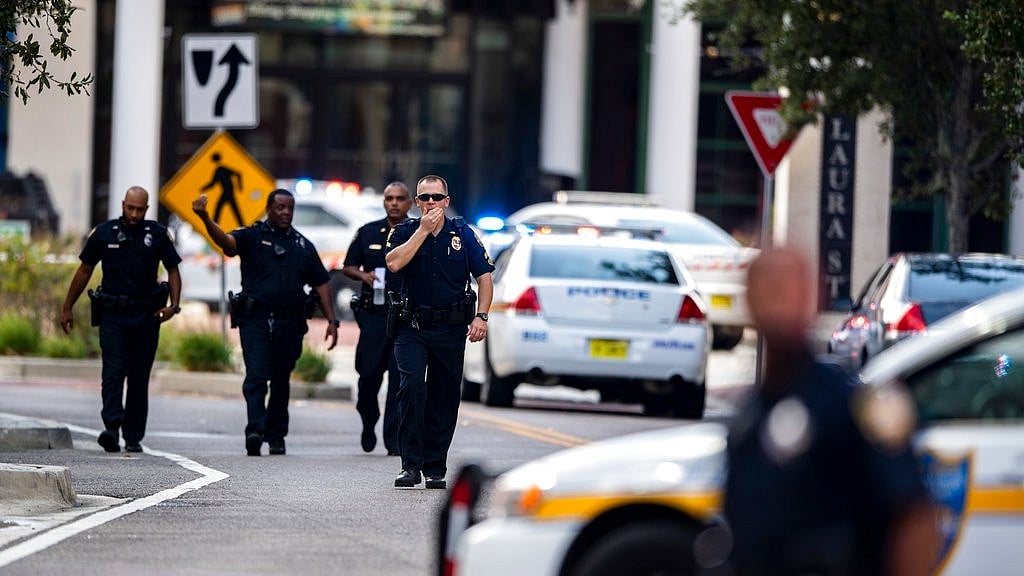 Police gather after an active shooter was reported at the Jacksonville Landing in Jacksonville.