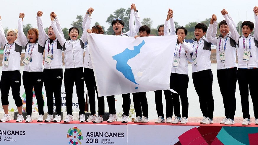 Members of combined Koreas team celebrate their victory during the ceremony for women’s 500-meter dragon boat at the 18th Asian Games in Palembang, Indonesia.