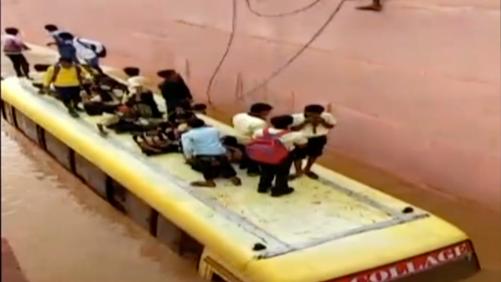 Students stood huddled on the roof of the submerged bus while the locals attempted to save them.