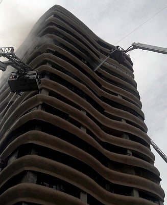 Mumbai: Fire fighters douse fire that broke out in the12th floor of 17-storeyed Crystal Tower building located in Parel, Mumbai, on  Aug 22, 2018. Four persons, including an elderly woman, were killed and 16 others injured, when a massive fire ripped through a highrise building. (Photo: IANS)