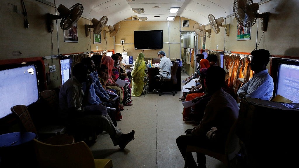 Patients wait for their dental checkup on the Lifeline Express, a hospital built inside a seven-coach train, at a railway station in Jalore, Rajasthan. 