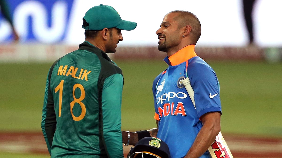 India’s Shikhar Dhawan, right, shares a light moment with Pakistan’s Shoaib Malik during the one day international cricket match of Asia Cup between India and Pakistan.