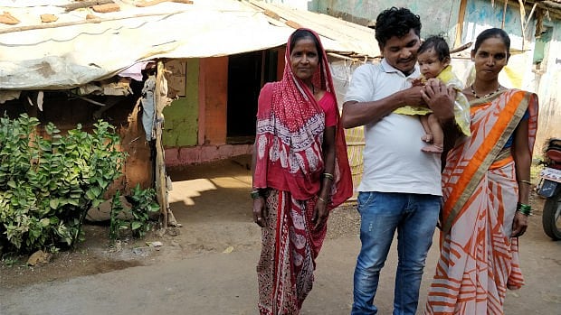 Kailash Burange holds his one-year-old daughter Sanskruti, as wife Arti and his mother stand next to him.&nbsp;