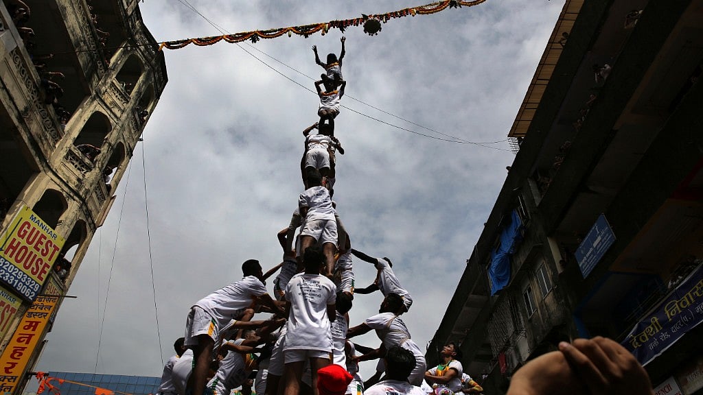 Indian youth form a human pyramid to break the “Dahi Handi,” to mark the Janmashtami festival