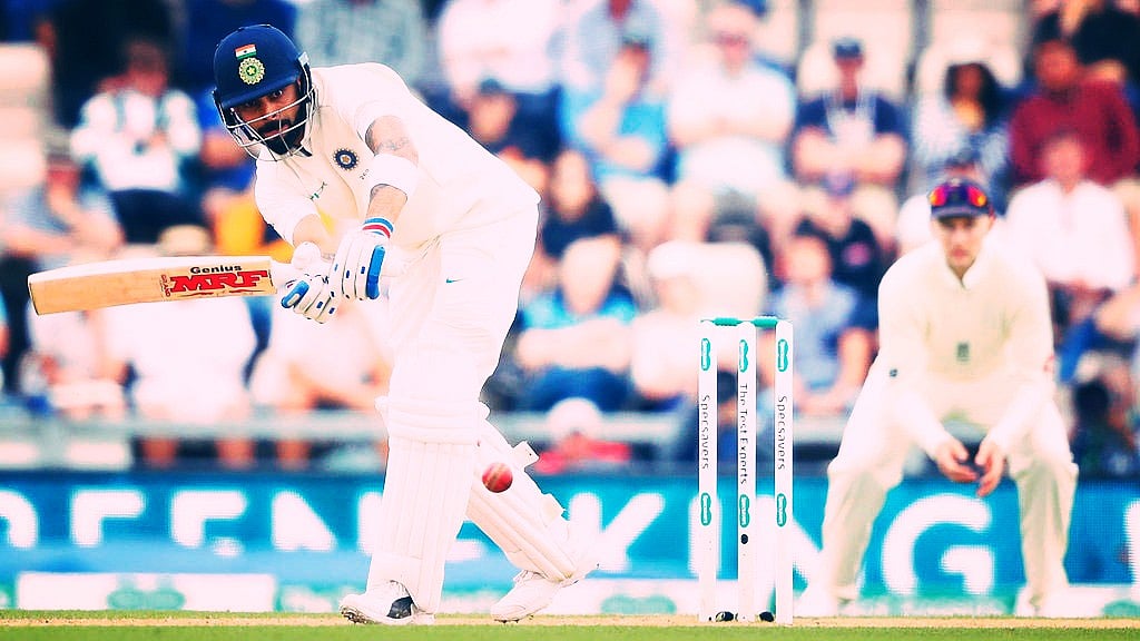 Virat Kohli plays a shot as Joe Root looks on during a Test match.