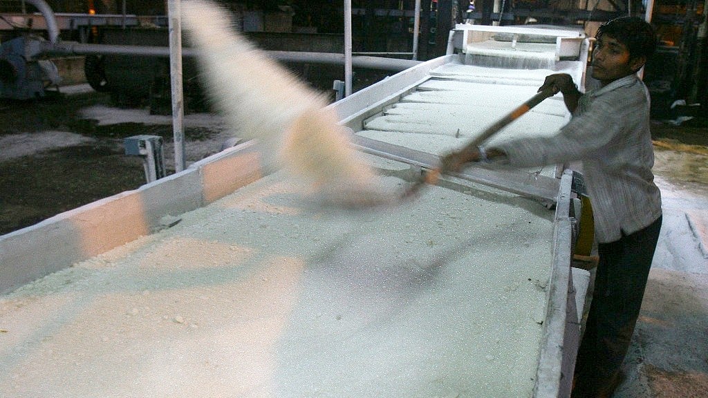 An employee works inside a sugar mill.