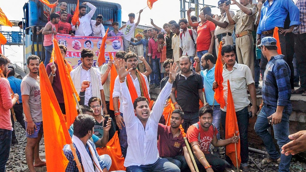 Swarn Sena activists stop a train during ‘Bharat Bandh’, called to press for reservation, in Patna on 6 September.
