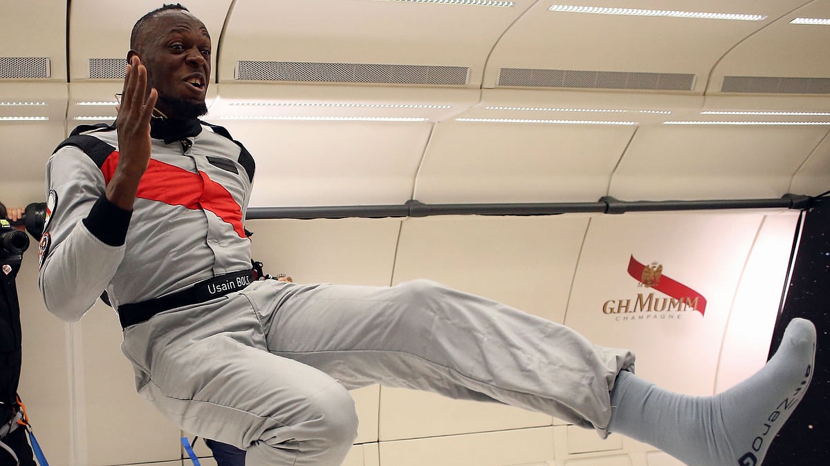 Jamaican athlete Usain Bolt, center, attempts to run, during a zero-gravity flight over France.