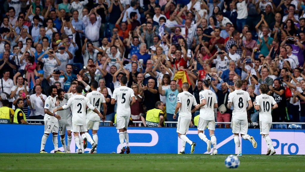 Real midfielder Isco celebrates with teammates after scoring his side’s opening goal during their Champions League match against Roma in Madrid on Wednesday.
