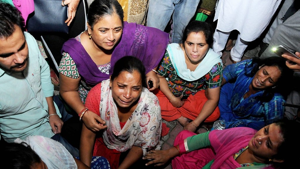 Relatives of train accident victims break down near the railway tracks in Amritsar where the accident took place.