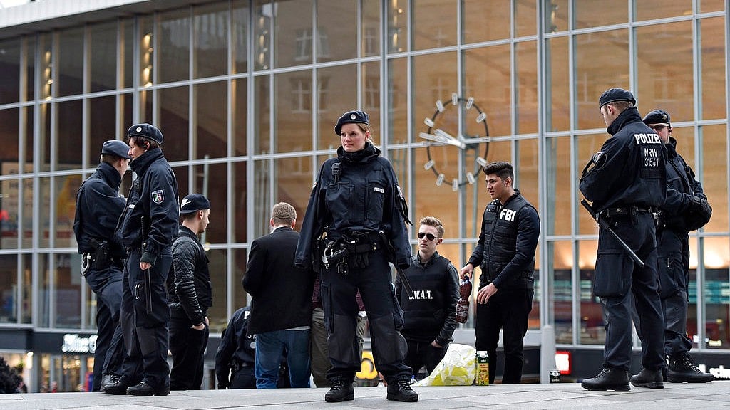 Police forces stand at the Cologne main station in western Germany on Monday,15 October.