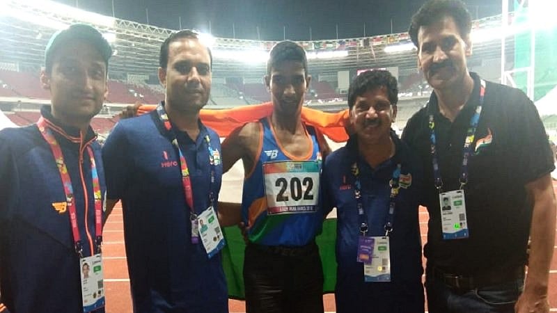 Narayan Thakur (centre) won the T35 100m final race in 14.02 seconds.