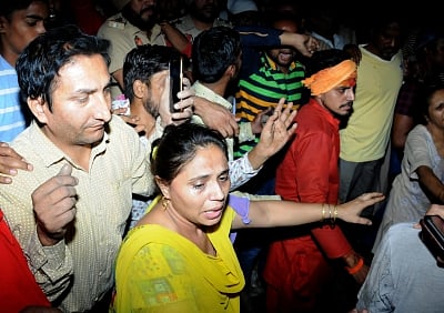 Amritsar: People gather at the site where at least 30 people glued to watching a burning Ravan effigy while standing on railway tracks were crushed by a speeding train in Amritsar on Oct 19, 2018. (Photo: IANS)