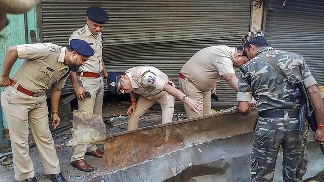 Police inspecting the area outside the building, at Nagerbazar in Kolkata’s Dum Dum, where the blast took place. 