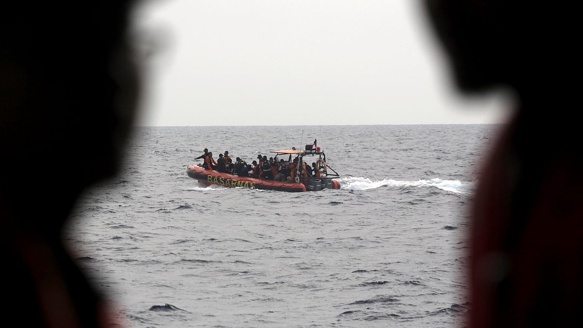 Rescue divers sit on a rubber boat during a search operation for the victims of Lion Air plane crash in the waters of Tanjung Karawang, Indonesia.