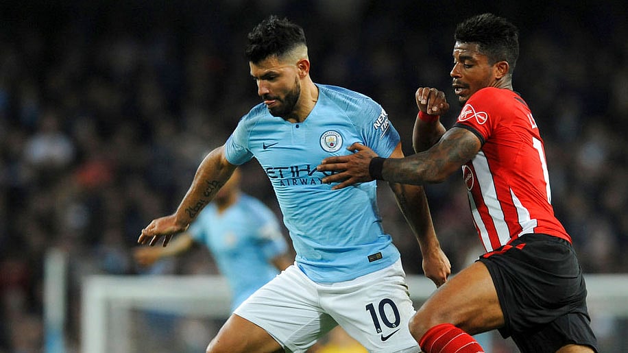 Manchester City’s Sergio Aguero, left, duels for the ball with Southampton’s Mario Lemina. 