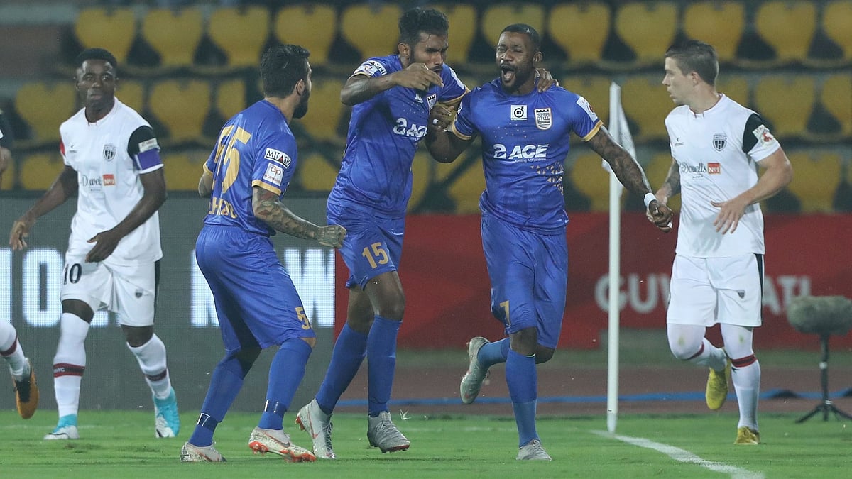 Mumbai City FC players celebrate their winning goal against NorthEast United FC in Guwahati on Friday.