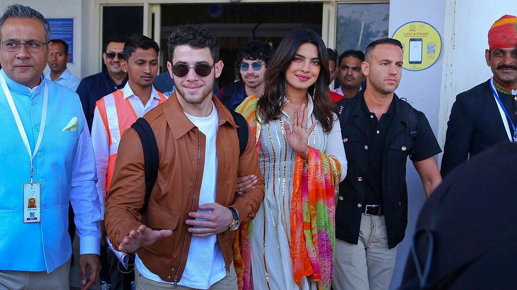 Priyanka and Nick wave to the paps as they arrive in Jodhpur. 