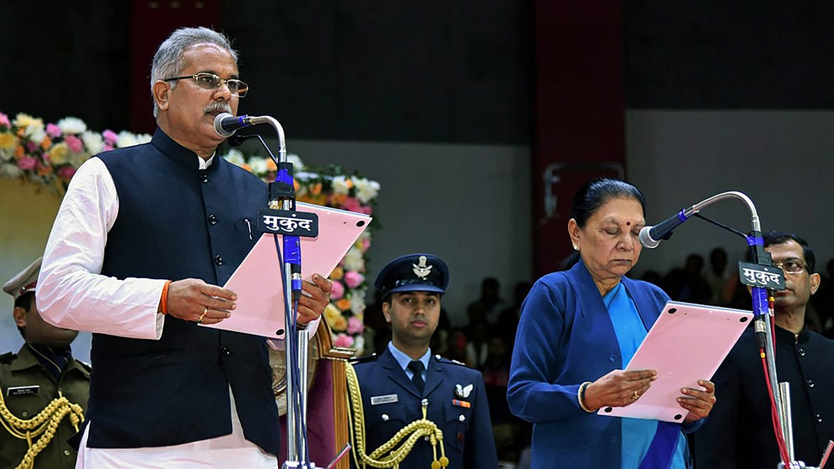 Chhattisgarh Chief Minister Bhupesh Baghel being administered the oath of office by Governor Anandiben Patel during a swearing-in ceremony, in Raipur.