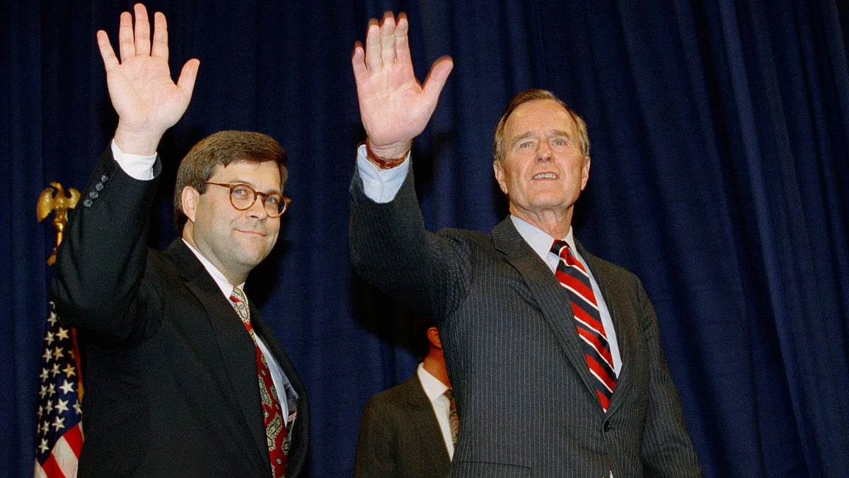 In this file photo, Former US President George HW Bush, right, and William Barr wave after Barr was sworn in as Attorney General of the United States in 1991.
