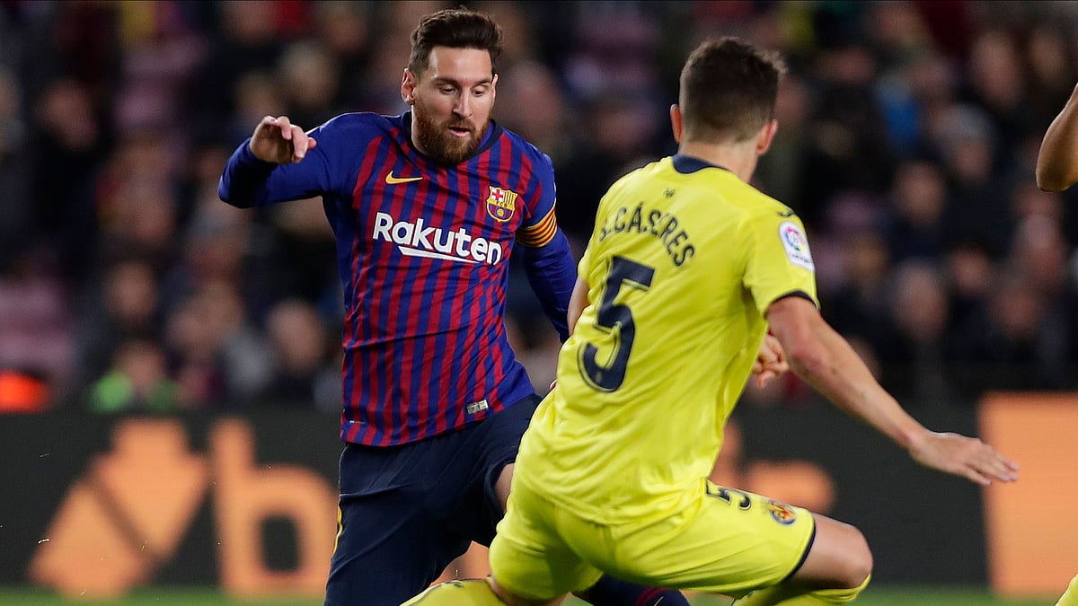 FC Barcelona’s Lionel Messi, left, duels for the ball with Villarreal’s Santiago Caseres during the Spanish La Liga soccer match between FC Barcelona and Villarreal.