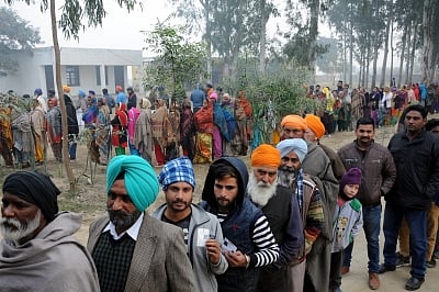 Amritsar: Voters wait in multiple queues to cast their votes for Punjab panchayat elections, at a polling booth in Amritsar on Dec 30, 2018. (Photo: IANS)