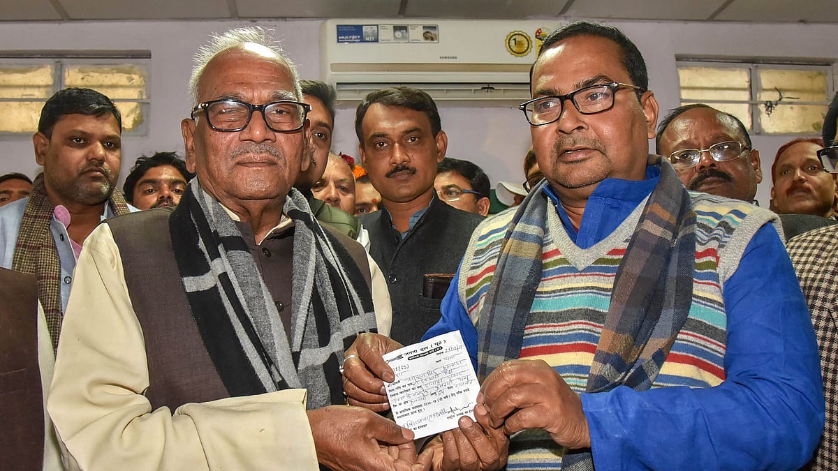 Bihar Janta Dal (United) President Vashishtha Narayan Singh presents the membership slip to former RLSP Vice-President Bhagwan Singh Kushwaha as he joins the JD(U) in Patna on 28 December.