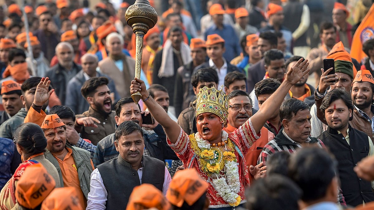 A supporter of Vishwa Hindu Parishad’s (VHP) dressed as Lord Hanuman lifts a mace during the ‘Dharma Sabha’ event.