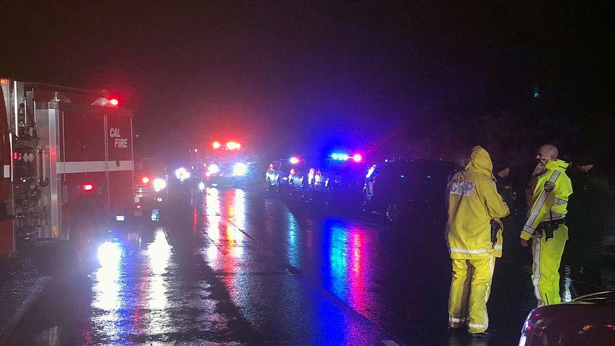 Firefighters work at the scene of a crash in California. Authorities say three people have been killed and eight injured when a pickup fleeing Border Patrol agents rolled over near the Mexican border.