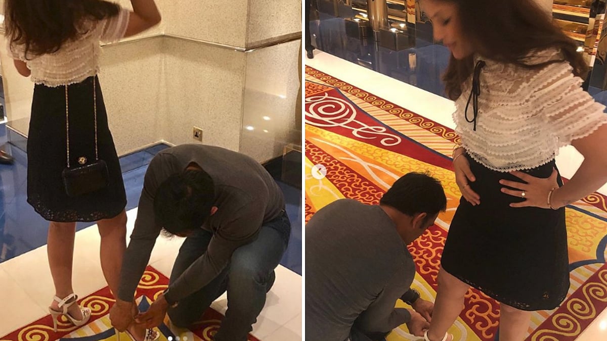 MS Dhoni ties his wife’s shoe lace.