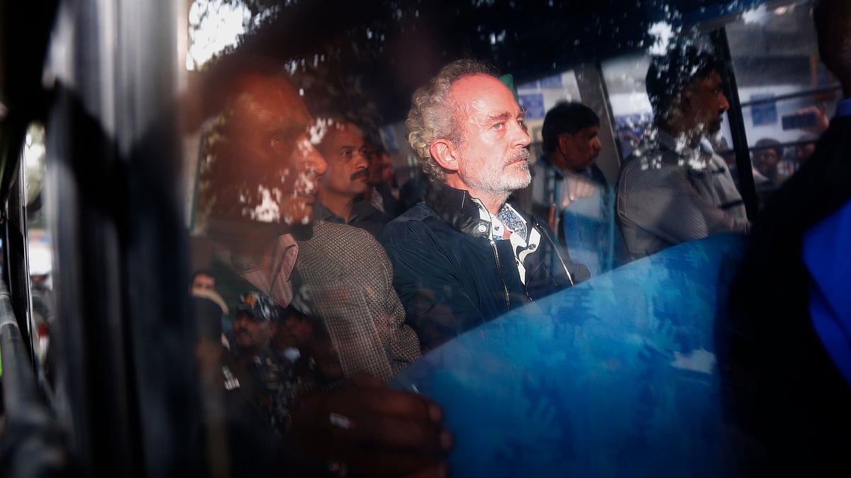 Christian James Michel (center), a British man accused of bribery in a $670 million helicopter deal between India and an Italian defense company returns after appearing before a CBI court in New Delhi.