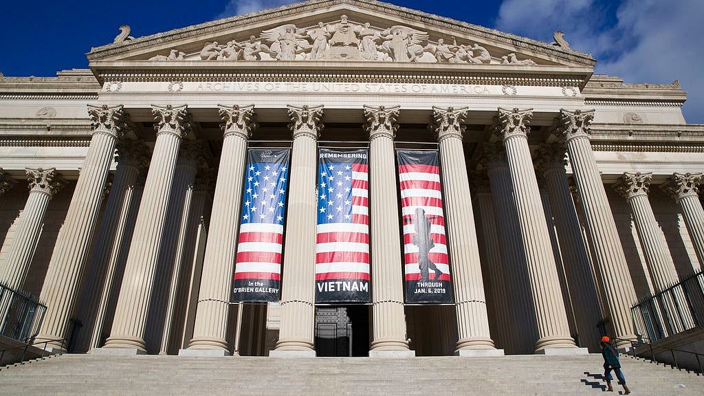 People walk up the steps even though the National Archives is closed with the partial government shutdown on 22 December. 