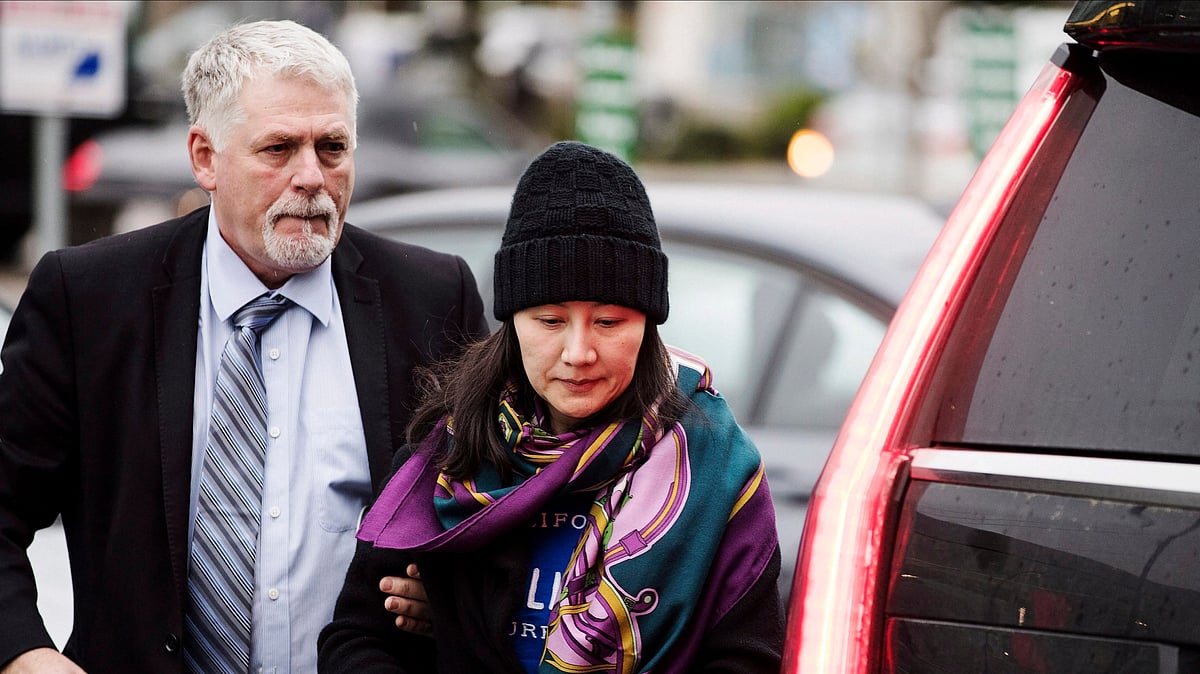 Huawei chief financial officer Meng Wanzhou arrives at a parole office with a security guard in Vancouver, British Columbia, Wednesday, Dec. 12, 2018. AP/PTI