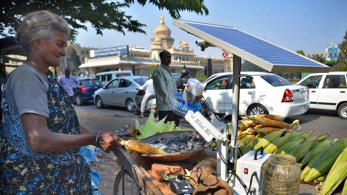 Selavamma grilling corn using solar fan.