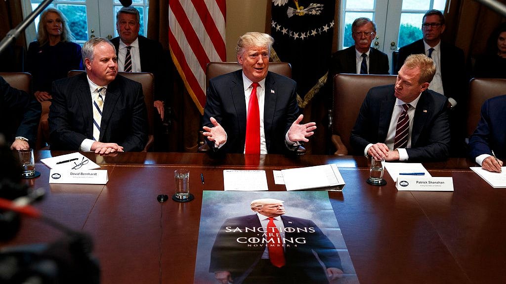 In this 2 January photo, acting Secretary of the Interior David Bernhardt, left, and acting Secretary of Defence Patrick Shanahan, right, listen as President Donald Trump speaks during a cabinet meeting at the White House in Washington.&nbsp;