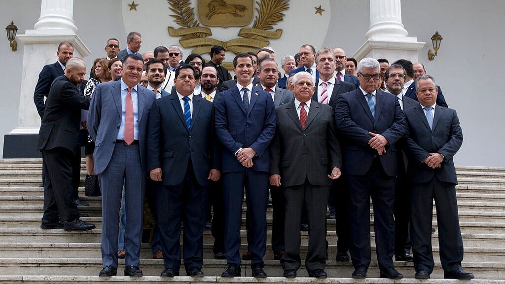 Juan Guaido, front center, poses for a photo with his colleagues prior to a special session of the National Assembly in Caracas, Venezuela. 