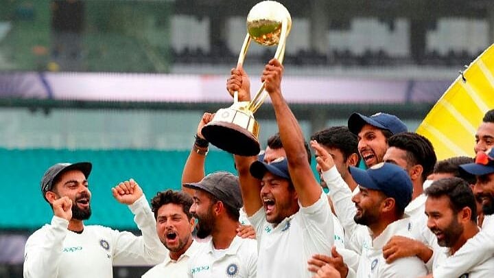 The Indian team holds aloft the Border-Gavaskar Trophy after securing India’s maiden Test series win in Australia.