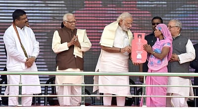 Ballia: Prime Minister Narendra Modi distributes free LPG connections to the beneficiaries, under Pradhan Mantri Ujjwala Yojana, in Ballia of Uttar Pradesh on May 1, 2016. Also seen Uttar Pradesh Chief Minister Ram Naik Union Petroleum Minister Dharmendra Pradhan and Union MSME Minister Kalraj Mishra. (Photo: IANS/PIB)
