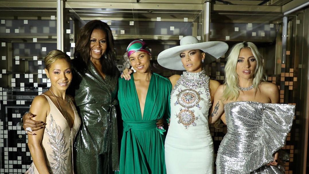 Michelle Obama stuns in a sparkling gunmetal pantsuit. 