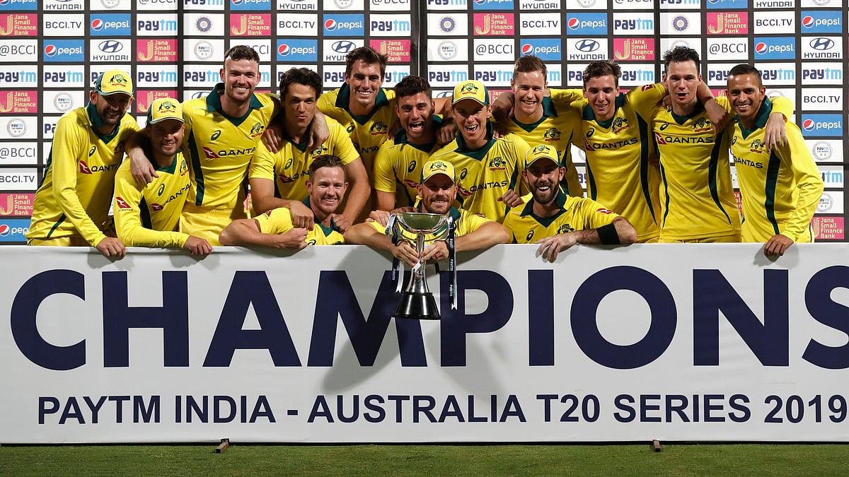 Members of Australian team pose with the winners trophy after their win in the second T20 international cricket match against India in Bangalore, India, Wednesday, Feb. 27, 2019. 