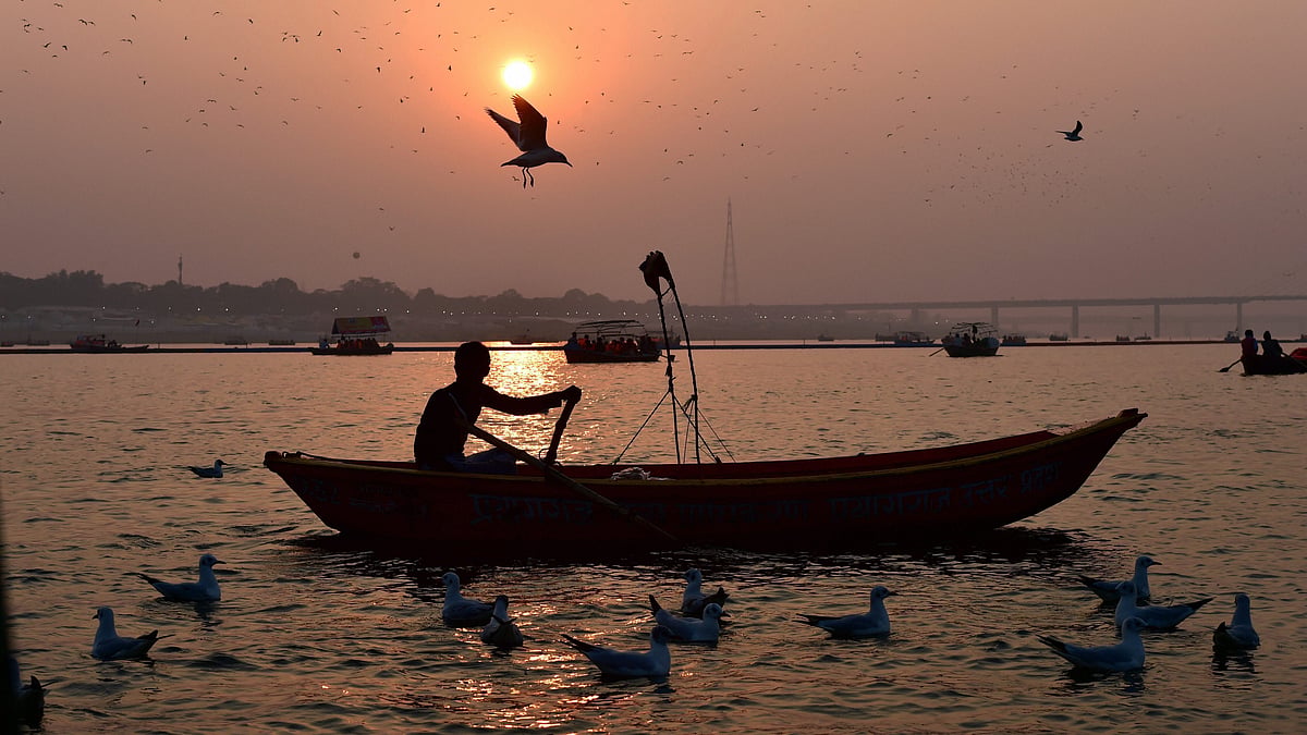 A man sails his boat as sunset during the Kumbh Mela 2019 at the Sangam in Allahabad.