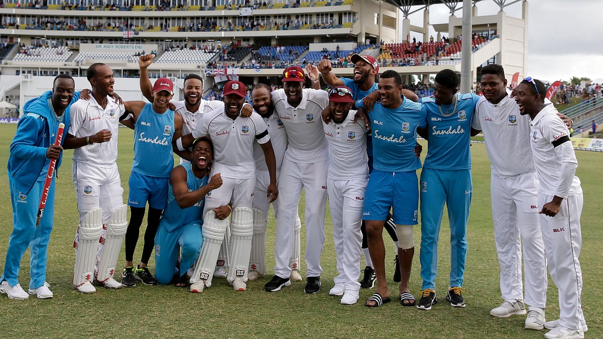 West Indies players celebrate beating England by ten wickets on day three of the second Test cricket match at the Sir Vivian Richards Stadium in North Sound, Antigua and Barbuda, Saturday, Feb. 2, 2019. 