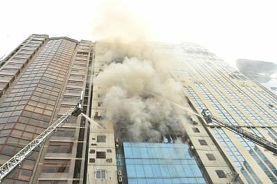 DHAKA, March 28, 2019 (Xinhua) -- Firefighters try to douse flame after a fire broke out at a high-rise building in Dhaka, Bangladesh on March 28, 2019. At least one person has died and 30 others rushed to hospital as a massive fire engulfed a high-rise building in Bangladesh capital Dhaka
