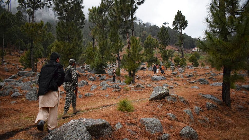 Pakistani reporters and troops visit the site of an Indian air strike in Jaba, near Balakot, Pakistan on 26 February. 