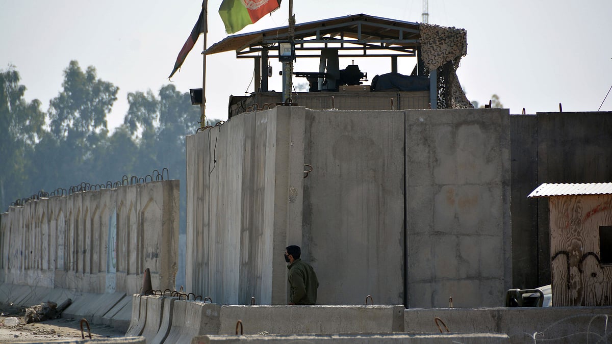 An Afghan security personnel stand guard in the checkpoint of airport after a suicide attack in Jalalabad province, east of Kabul, Afghanistan.