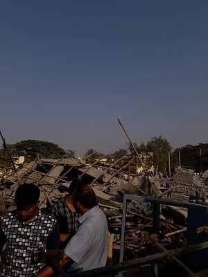 Dharwad: People gather at the site where an under construction multi-storey building collapsed leaving two people killed and 50 others trapped in Karnataka